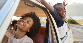 Mother And Children Relaxing In Car During Road Trip